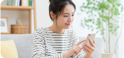 自宅でスマートフォンを使ってAI面接を練習する女性
